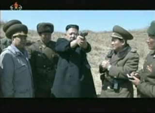Still image from video shows North Korea's leader Kim Jong-un holding up a pistol as he supervises pistol and automatic file firing drills at the second battalion under North Korea People's Army