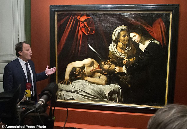 Auction officer Marc Labarbe presents the painting to the media in Paris, Tuesday, April 12, 2016. A 400-year-old painting that might have been executed by Italian master Caravaggio and could be worth more than 100 million euros has been found in an attic in Southern France.The picture, whose authenticity has not been established, had been left for more than 150 years in a property in the outskirts of Toulouse. (AP Photo/Michel Euler)